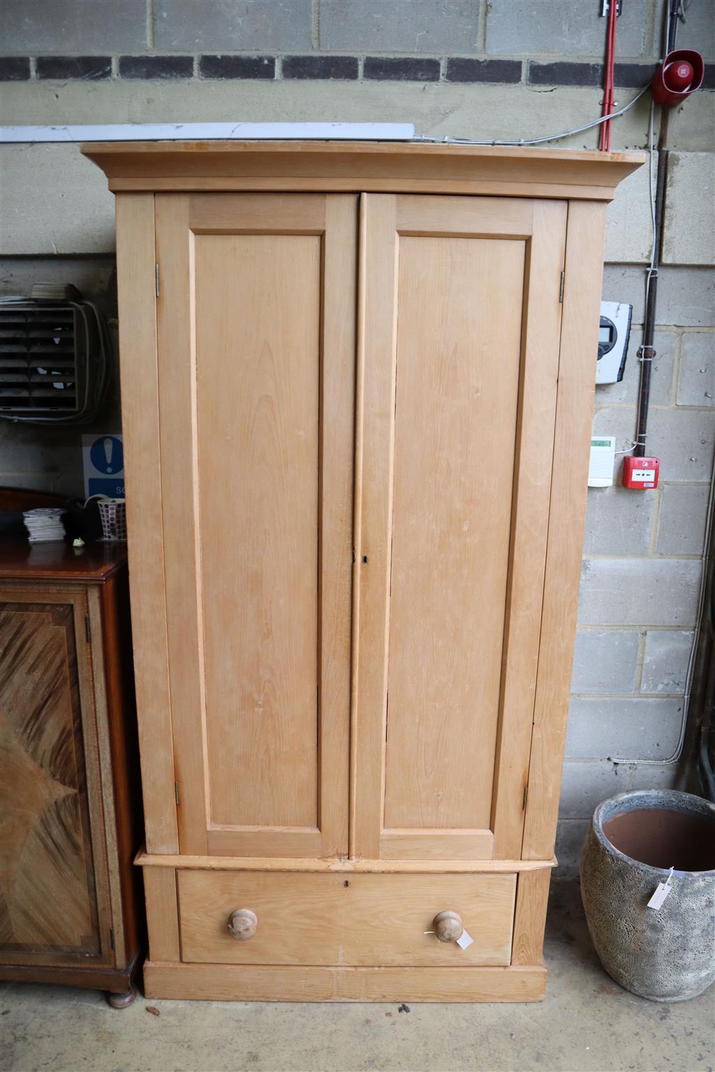 A late Victorian pine wardrobe, width 115cm, depth 51cm, height 215cm